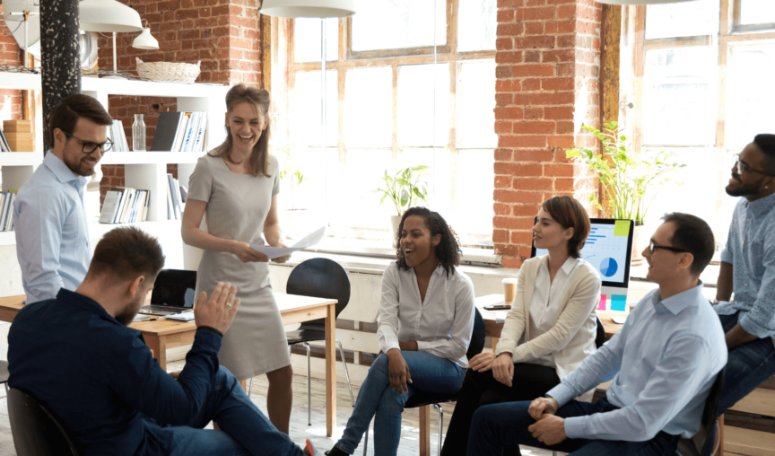 a group of employees having a meeting and smiling